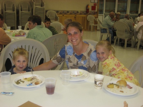 Jacob, Renita, and Chrissy Petersheim enjoying a meal