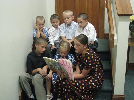 Molly (Jason's) reads to the children before the service after practicing with them for some singing