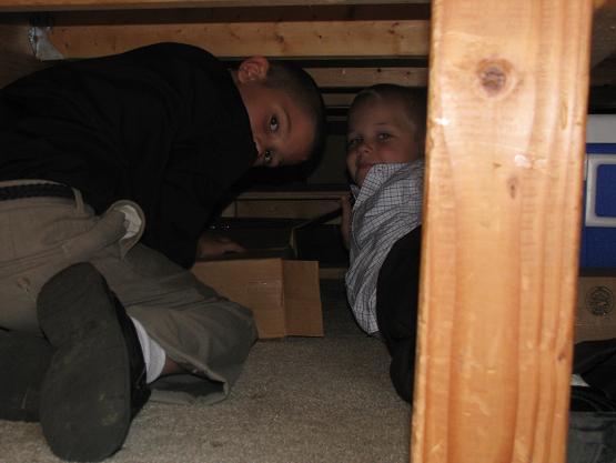 Bryce (Brian's) and Guy (Daryl's) digging out CD's from under the bus bed to restock the CD stand.